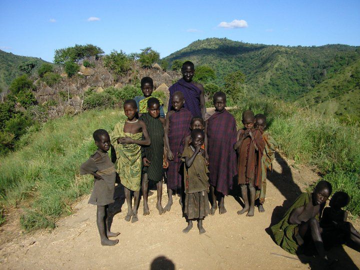IK people family possing for a photo during a uganda safari tour in kidepo national park